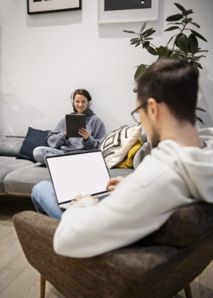 couple-working-together-from-home-devices
